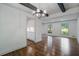 Elegant dining and adjacent kitchen features wood floors, large windows, and modern lighting at 3937 Locklear Way, Atlanta, GA 30360