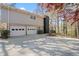 Home exterior highlighting a screened-in porch and the two-car garage, complemented by mature trees and landscaping at 3937 Locklear Way, Atlanta, GA 30360