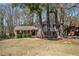 Exterior view of a brick and siding home surrounded by mature trees and landscaping at 3937 Locklear Way, Atlanta, GA 30360