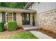 Inviting entryway featuring a black front door, manicured bushes, and a well-maintained brick facade at 3937 Locklear Way, Atlanta, GA 30360