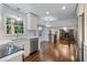 Open concept kitchen showcasing stainless steel appliances, bright countertops, and hardwood flooring throughout at 3937 Locklear Way, Atlanta, GA 30360