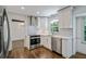Stylish kitchen featuring stainless appliances, white cabinets and patterned tile backsplash at 3937 Locklear Way, Atlanta, GA 30360