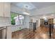 Bright kitchen nook featuring hardwood floors, stainless steel appliances, and an open view to the living room at 3937 Locklear Way, Atlanta, GA 30360