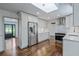 Modern kitchen with stainless appliances, white cabinets and tile, and stylish flooring at 3937 Locklear Way, Atlanta, GA 30360