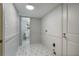 Practical laundry area with modern geometric tile flooring and adjacent half bath at 3937 Locklear Way, Atlanta, GA 30360