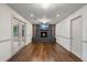 Cozy living room boasting hardwood floors, a brick fireplace with a TV, and double doors to the patio at 3937 Locklear Way, Atlanta, GA 30360