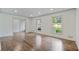 Open-concept living room with hardwood floors, white trim, and large windows, creating an inviting atmosphere at 3937 Locklear Way, Atlanta, GA 30360