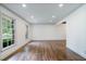 Spacious living room featuring hardwood floors, white walls, and large windows offering ample natural light at 3937 Locklear Way, Atlanta, GA 30360