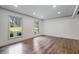 Bright living room showcasing hardwood floors, white walls, recessed lighting, and large windows at 3937 Locklear Way, Atlanta, GA 30360