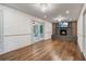 Living room with fireplace, modern lighting, hardwood floors, and doors to screened in porch at 3937 Locklear Way, Atlanta, GA 30360