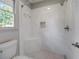Elegant shower with marble tile, corner seat, and modern fixtures at 3937 Locklear Way, Atlanta, GA 30360