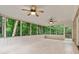 Bright sunroom featuring tile flooring, white wood paneled walls, and large windows with views of the surrounding greenery at 3937 Locklear Way, Atlanta, GA 30360
