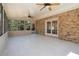 Enclosed sunroom with tile flooring, ceiling fans, brick accent wall, and screened windows leading to the outdoors at 3937 Locklear Way, Atlanta, GA 30360
