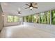 Spacious sunroom with tile flooring, white walls, and large screened windows offering tranquil views of the wooded yard at 3937 Locklear Way, Atlanta, GA 30360