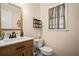 Charming half bathroom features modern vanity with updated fixtures and decorative shelving at 4967 Jett Rd, Marietta, GA 30066