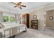 Comfortable bedroom featuring tray ceilings, a ceiling fan, neutral colors, and a large window with natural light at 4967 Jett Rd, Marietta, GA 30066
