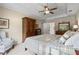 Comfortable bedroom with tray ceilings, ceiling fan, natural light, and a full dresser with mirror at 4967 Jett Rd, Marietta, GA 30066