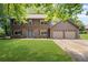 Charming two-story home with a well-manicured lawn, blue front door, and an attached two-car garage at 4967 Jett Rd, Marietta, GA 30066