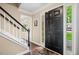 Inviting foyer with hardwood floors, staircase with black railing, and a dark wood front door at 4967 Jett Rd, Marietta, GA 30066