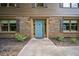Inviting front entrance with a blue door, brick facade, and manicured landscaping at 4967 Jett Rd, Marietta, GA 30066