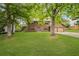 A lush green lawn surrounds this inviting home, nestled amongst mature trees, with a welcoming driveway at 4967 Jett Rd, Marietta, GA 30066