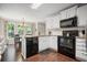 Modern kitchen with white cabinets, stainless steel appliances, and breakfast nook at 4967 Jett Rd, Marietta, GA 30066