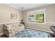 Sunlit living room featuring hardwood floors, a stylish sofa, and a view to the neighborhood at 4967 Jett Rd, Marietta, GA 30066