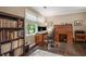 Cozy home office with a rolltop desk, bookshelf, and natural light from the window at 4967 Jett Rd, Marietta, GA 30066