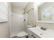Clean bathroom featuring white tile, a single sink vanity, and a shower with updated fixtures at 586 Chris Cir, Lawrenceville, GA 30044