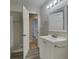 Bathroom featuring a white vanity, mirror, and a door leading to other rooms at 586 Chris Cir, Lawrenceville, GA 30044