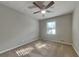 Neutral bedroom with a ceiling fan, carpeted floor, and window letting in sunlight at 586 Chris Cir, Lawrenceville, GA 30044