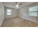 Comfortable bedroom featuring neutral walls, a ceiling fan, and ample natural light at 586 Chris Cir, Lawrenceville, GA 30044