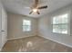 Sunny bedroom with carpet, two windows, and a closet for ample storage at 586 Chris Cir, Lawrenceville, GA 30044