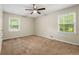 Spacious bedroom with neutral walls, plush carpet, and large windows providing ample natural light at 586 Chris Cir, Lawrenceville, GA 30044