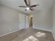 Cozy bedroom with carpeted floor, a ceiling fan, and white closet doors at 586 Chris Cir, Lawrenceville, GA 30044