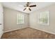 Inviting bedroom with neutral walls, plush carpet, and ceiling fan at 586 Chris Cir, Lawrenceville, GA 30044