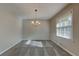 Bright dining room featuring a modern chandelier and large windows at 586 Chris Cir, Lawrenceville, GA 30044
