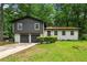 Charming split-level home featuring a two-car garage, neutral paint scheme, and a spacious front yard at 586 Chris Cir, Lawrenceville, GA 30044