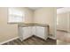 Bright kitchen area with white cabinets, granite countertops, and modern laminate flooring at 586 Chris Cir, Lawrenceville, GA 30044