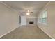 Cozy living room with neutral walls, a decorative fireplace, and a ceiling fan at 586 Chris Cir, Lawrenceville, GA 30044