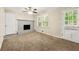 Cozy living room featuring a painted brick fireplace, neutral walls, and access to the backyard at 586 Chris Cir, Lawrenceville, GA 30044