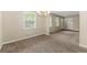 Cozy living room featuring neutral paint, plush carpet, and a classic chandelier lighting fixture at 586 Chris Cir, Lawrenceville, GA 30044