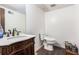 Simple bathroom featuring a marble-top vanity with dark wood accents, a toilet, and updated faucet at 6230 S Summers S Cir, Douglasville, GA 30135