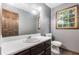 Functional bathroom featuring updated fixtures and a dark wood framed mirror, ready for renovation at 6230 S Summers S Cir, Douglasville, GA 30135