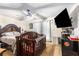 Cozy bedroom featuring neutral tones, a ceiling fan, TV, and a charming crib, ideal for a Bedroom at 6230 S Summers S Cir, Douglasville, GA 30135