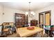 Traditional dining room with wooden table, chandelier, and classic wood accents at 6230 S Summers S Cir, Douglasville, GA 30135