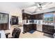 Well-lit kitchen with dark cabinets, stainless steel dishwasher and views into adjoining rooms at 6230 S Summers S Cir, Douglasville, GA 30135