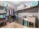 Well-organized laundry room with stainless steel washer and dryer, ample shelving, and practical utility sink at 6230 S Summers S Cir, Douglasville, GA 30135