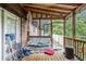 Cozy screened porch with a swing, perfect for relaxing and enjoying the outdoors at 6230 S Summers S Cir, Douglasville, GA 30135