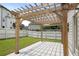 Backyard patio featuring a wooden pergola and concrete base, perfect for outdoor relaxation at 829 Overlook Path Ln, Lawrenceville, GA 30045